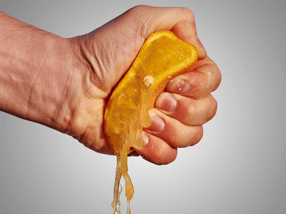 hand squeezing orange